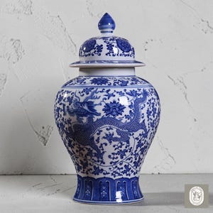 May include: A blue and white ceramic ginger jar with a lid. The jar features a dragon design and floral patterns. The jar is approximately 12 inches tall.