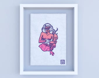 May include: A framed illustration of a woman with pink and purple hair holding a mushroom in her arms. The illustration is on a white background and has a signature in the bottom right corner that says "2020 MNM".