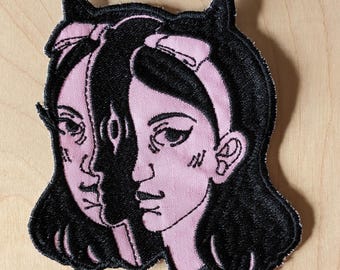 Sew-on machine embroidered patch | Black on Pink | Devil girl portrait | Surreal art from Montreal