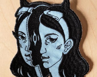 Sew-on machine embroidered patch | Black on Blue | Devil girl portrait | Surreal art from Montreal