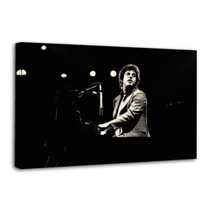 May include: Monochrome photograph of a man performing on a piano on stage. The man is wearing a suit and tie, and the stage is lit with spotlights. The image is a canvas print.