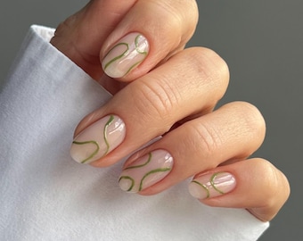 Uñas postizas minimalistas verde salvia con diseño de remolino, uñas de gel ovaladas abstractas.