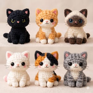 May include: Six crocheted cat figurines in various colors: black, orange, Siamese, white, calico, and gray. Each cat has large, expressive eyes, a pink nose, and whiskers. The cats are sitting upright, showcasing their handmade details.
