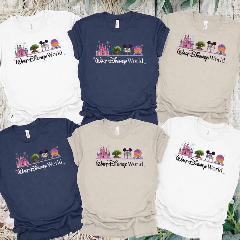 May include: Six t-shirts in various colors, including white, navy blue, and tan. Each shirt features a graphic of a castle, tree, Mickey Mouse, and a planet with the text "Walt Disney World" in a script font.