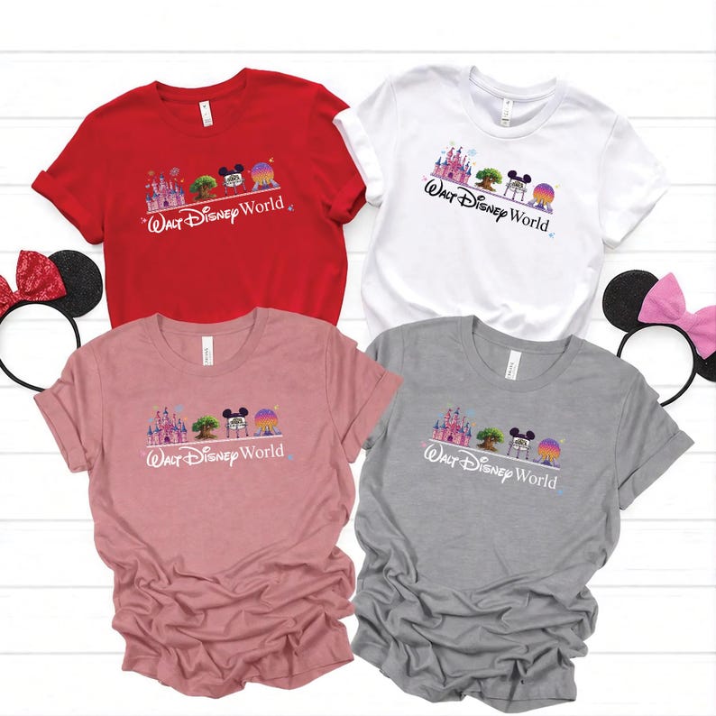 May include: Four short-sleeved t-shirts in red, white, pink, and gray, each featuring a colorful graphic of a castle, tree, Mickey Mouse, and a sphere, with "Walt Disney World" text. Black and pink Minnie Mouse ear headbands are visible.