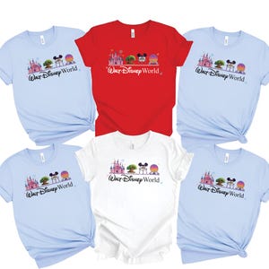 May include: A collection of short-sleeved t-shirts in various colors, including light blue, red, and white. Each shirt features a graphic of a castle, tree, Mickey Mouse ears, and a sphere, with the text "Walt Disney World".