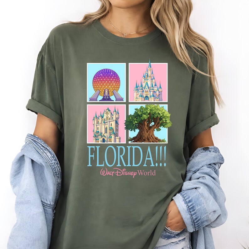 May include: Olive green t-shirt featuring four square images of Florida landmarks, including a sphere, a castle, and a tree. The word "FLORIDA!!!" is printed in blue, with "Walt Disney World" below.