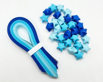 May include: A set of blue and light blue origami paper strips and a pile of folded origami stars in shades of blue.