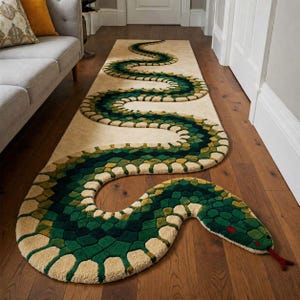 May include: A beige runner rug with a green and yellow snake design. The snake's body is segmented with varying shades of green and yellow, and the head features a red tongue. The rug is placed on a wooden floor.