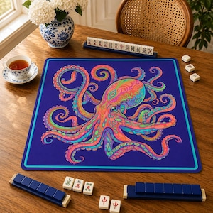 May include: A square game mat featuring a vibrant, multi-colored octopus illustration with swirling patterns in shades of pink, orange, green, and blue set against a deep navy blue background with a thin teal border frame.