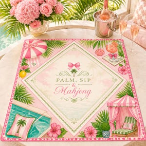 May include: A pink and green placemat with a tropical theme. The placemat features the text "PALM, SIP & Mahjong" in a diamond-shaped design, surrounded by palm trees, flowers, and a pool scene. A cocktail and champagne glasses are also visible.