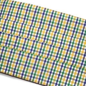 May include: A yellow, green, and blue plaid fabric with a subtle sheen. The fabric is folded in thirds and has a smooth texture.