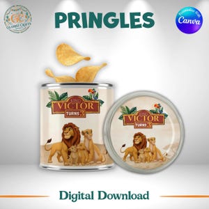 May include: A cylindrical Pringles snack container and its lid featuring a custom label with a lion family illustration, green leaves, and the text King Victor Turns 3. Three golden potato chips are emerging from the top of the open container.