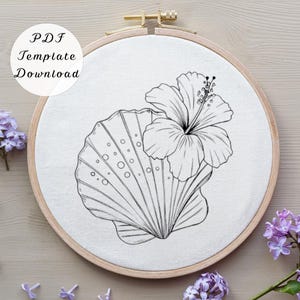 May include: A black and white line drawing of a seashell and hibiscus flower is stretched across a white fabric within a wooden embroidery hoop. The text "PDF Template Download" is in the upper left corner.