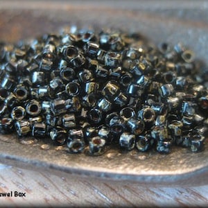 Size 11/0 Miyuki Delica Seed Bead - Jet Black Picasso, 5 grams