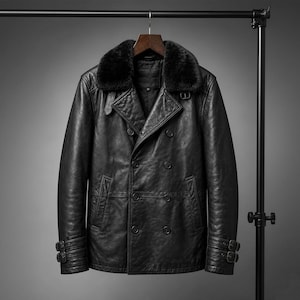 May include: A black leather jacket with a faux fur collar, double-breasted front, and buckle details on the cuffs. The jacket is hanging on a black metal clothing rack. The jacket has a classic, timeless design.