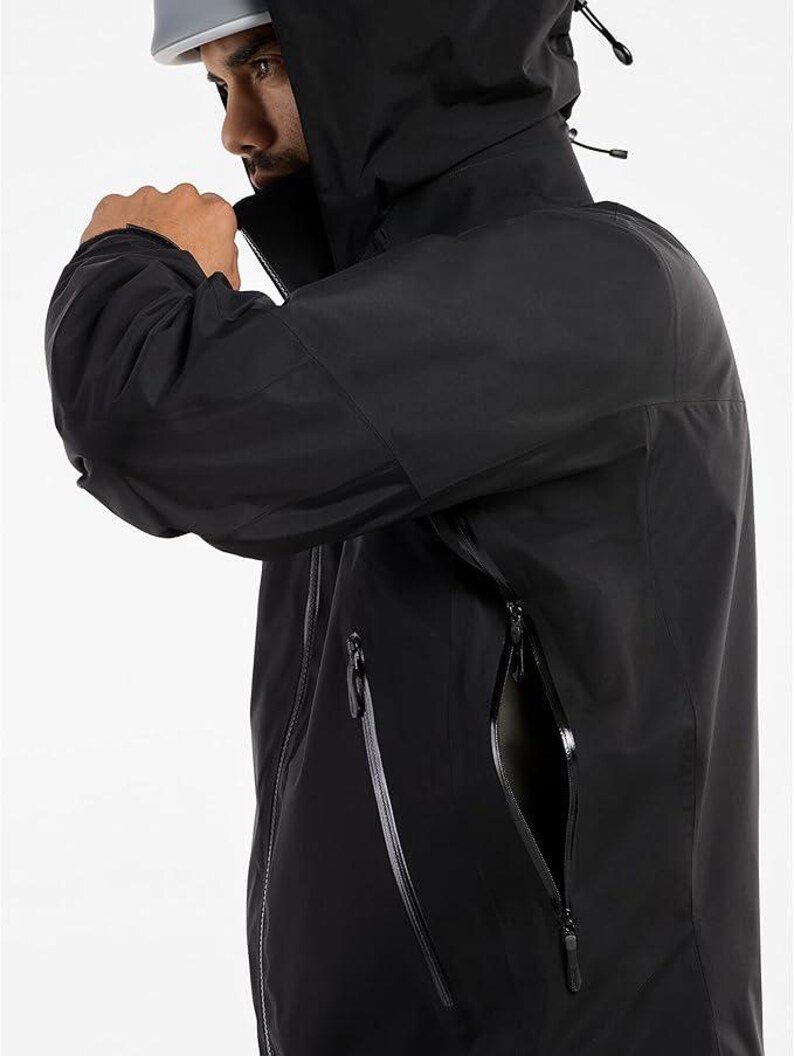 May include: Black hooded jacket with a high collar and multiple zippered pockets. The jacket has a sleek, modern design, with a focus on functionality and weather protection. The jacket is made of a durable, water-resistant material.