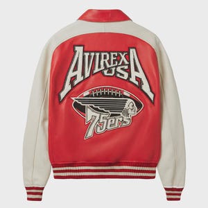 May include: A red and cream-colored leather jacket with the text "AVIREX USA" and a football graphic on the back. The jacket has a ribbed hem and cuffs with red and white stripes. The jacket has a red collar.