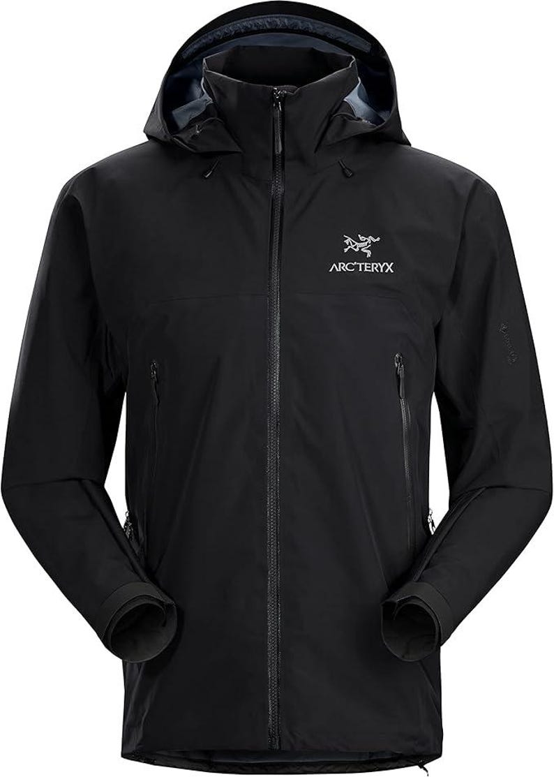 May include: Black hooded jacket with a full-length zipper and two side pockets. The jacket features the Arc'teryx logo on the chest. The jacket has a high collar and a hood for added protection from the elements. The sleeves have adjustable cuffs.