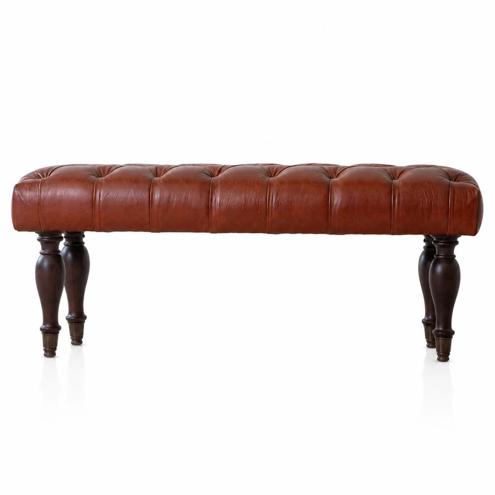 Cognac leather bench with tapered wooden legs for a western coastal bedroom
