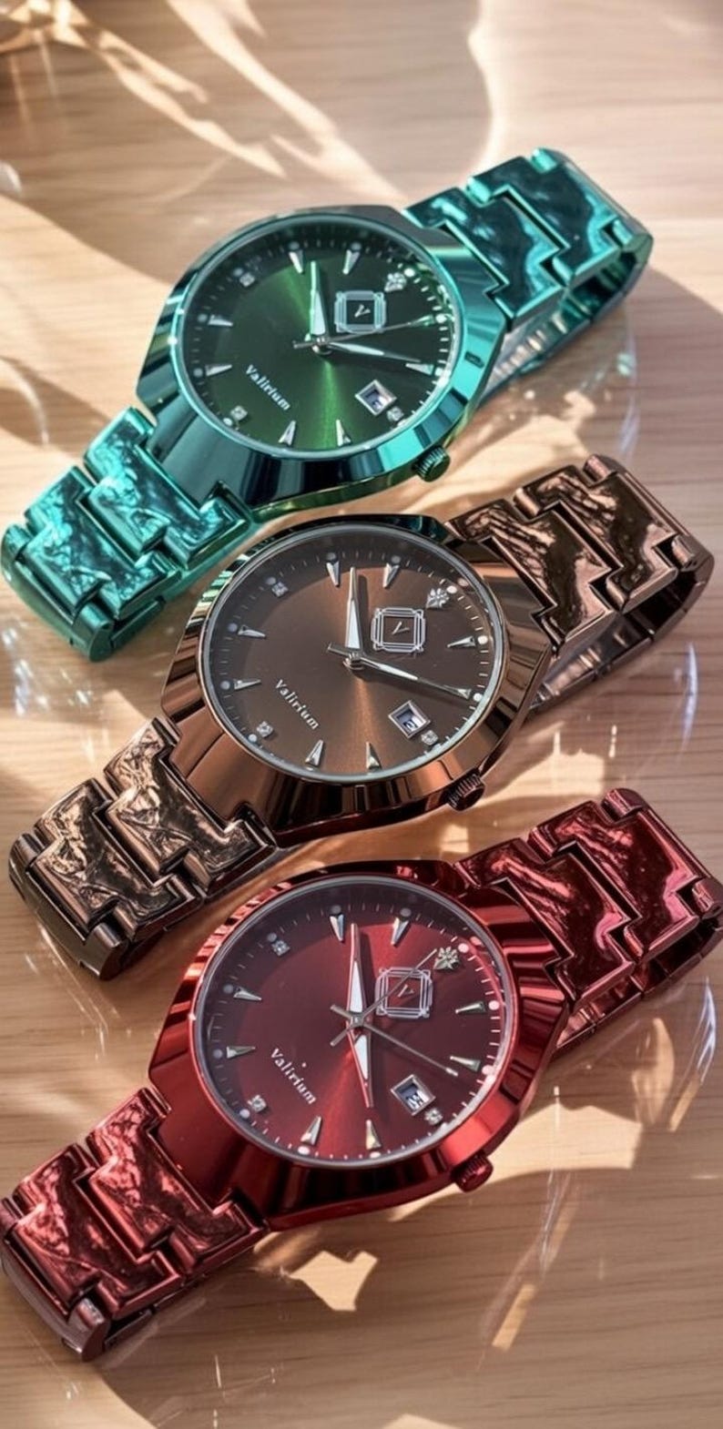 May include: Three metallic watches in green, bronze, and red, each with a matching band. The watch faces display the brand name "Valirium" and a date window. The watches are on a light-colored wooden surface.