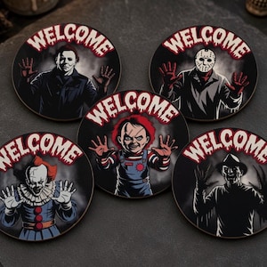May include: Five circular coasters featuring horror movie characters including Michael Myers, Jason Voorhees, Chucky, Pennywise, and Freddy Krueger. Each coaster displays the character with hands raised and the word WELCOME in dripping red letters.