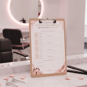May include: A brown clipboard featuring a printed Mixing Ratio Reference & Quick Formula Log with sections for formulas, processing times, and notes. The document is decorated with pink floral accents and includes a metal clip at the top.