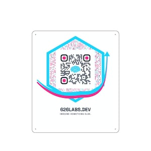 May include: A white square sign featuring a central hexagonal QR code with a blue brain icon in the middle. The design includes pink and blue curved lines and arrows. Below the graphic, the text reads 626LABS.DEV and IMAGINE SOMETHING ELSE.