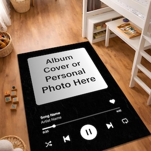 May include: A white ceramic mug with a black handle and the text "But First, Coffee" in a bold, black font. The mug is set against a blurred background, highlighting its simple design.