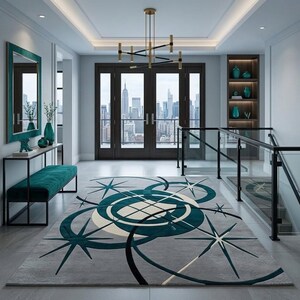 May include: A rectangular area rug featuring a grey background with a geometric pattern of teal circles and dark blue starburst shapes. The rug is positioned in a hallway with a teal bench, a console table, and a view of a city skyline.