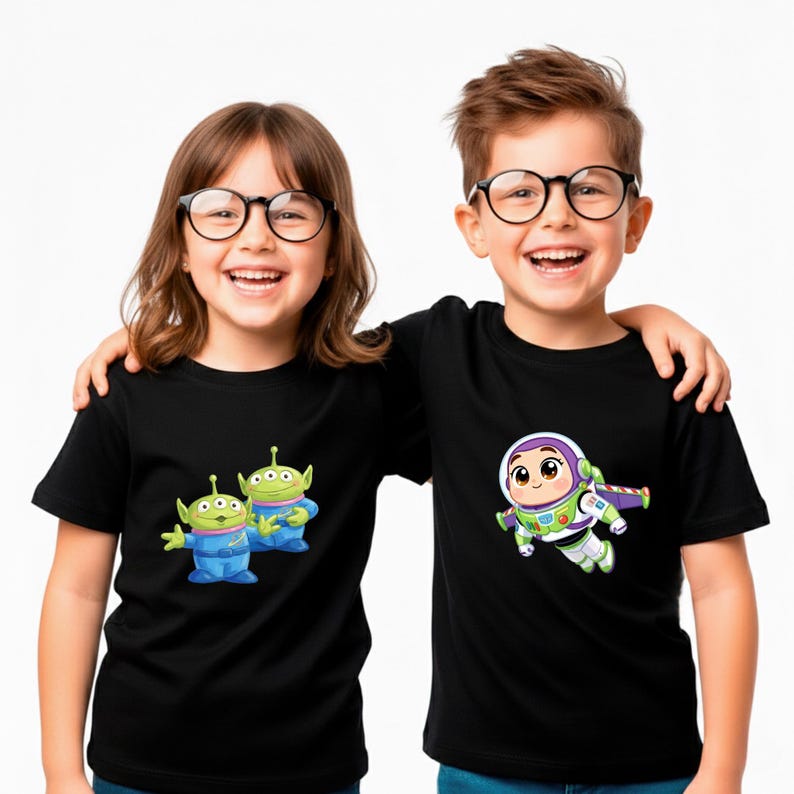 May include: Two children wearing black t-shirts with cartoon graphics. One shirt features the Toy Story aliens, the other features Buzz Lightyear. Both children are smiling and wearing glasses.