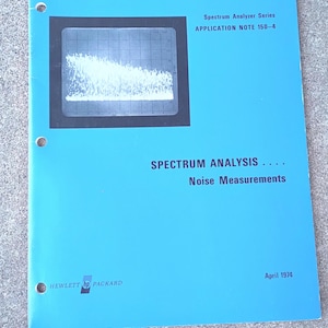 May include: A white ceramic mug with a black handle and the text "But First, Coffee" in a bold, black font. The mug is set against a neutral background, highlighting its simple design.
