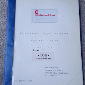 May include: A vintage document titled "DISCRIMINATE AUDIO PROCESSOR AGC-PEAK LIMITER MODEL 310." The cover is off-white with a blue spine. The document includes the Cetec Broadcast Group logo and address, along with the manufacturer's details: Dorrough Electronics, Woodland Hills, California.