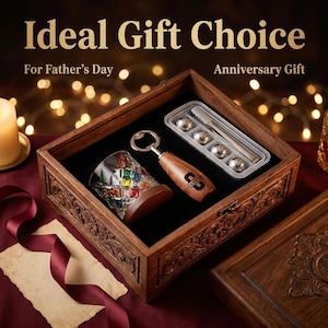 May include: A wooden gift box with a black velvet interior contains a whiskey glass with colorful accents, a bottle opener, and a set of stainless steel ice spheres. The box is engraved and the bottle opener has a logo.