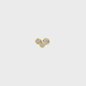 May include: A gold stud earring featuring three circular bezel settings arranged in a cluster. Each setting contains a small, clear, round-cut gemstone. The metal has a polished, reflective finish, and the design creates a compact, rounded shape.