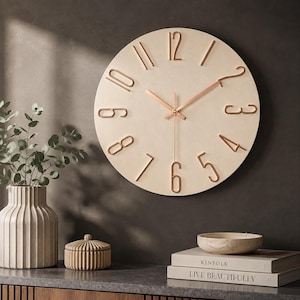 May include: A circular wall clock with a light wood grain face and raised copper-coloured numerals. The clock features thin, matching copper-coloured hour, minute, and second hands. The design includes a clean, open layout with metallic numbers.