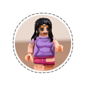 May include: A Lego figurine of a character with black hair, orange sunglasses, and a purple top. The figure is wearing pink shorts and has a smiling expression. The figurine is inside a white circle with a dashed border.