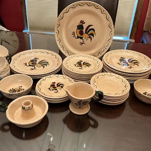 May include: A set of three ceramic vases in varying heights. The vases are white with a textured, ribbed design. The tallest vase is approximately 10 inches tall, the medium vase is 8 inches, and the smallest is 6 inches.