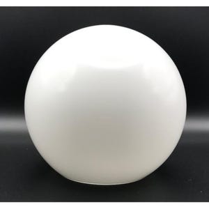 May include: A smooth, spherical white glass lamp shade with a glossy finish. The globe features a uniform, opaque white surface that diffuses light evenly. This round lighting component is designed to be mounted onto a compatible light fixture base.