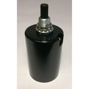 May include: A black cylindrical light bulb socket featuring a metallic threaded top component with a central black push-button switch. The exterior surface is smooth and glossy, with a small side opening for wiring and visible embossed text.