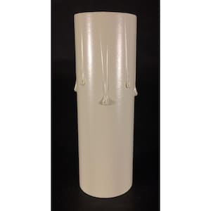 May include: A cylindrical candle cover in an off-white color featuring a smooth surface with raised, vertical drip-like textures extending downward from the top edge, designed to mimic the appearance of melting wax on a traditional pillar candle.
