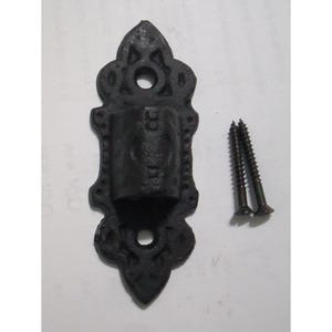 May include: A black cast iron wall bracket with an ornate, elongated shape featuring two circular mounting holes at the top and bottom, accompanied by two matching black metal screws for installation purposes.