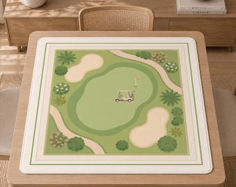 May include: A square mat featuring a top-down illustration of a golf course. The design includes a green putting area, beige sand bunkers, winding paths, various green trees, and a small pink golf cart with a flag near the center.