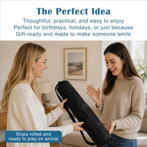 May include: A black cylindrical carrying case with a shoulder strap. The text on the image reads: The Perfect Idea, Thoughtful, practical, and easy to enjoy, Perfect for birthdays, holidays, or just because, Gift-ready and made to make someone smile, Ships rolled and ready to play on arrival.