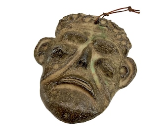 Clay figurine featuring a male face, Denmark 1970.