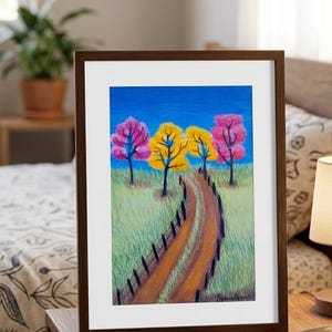 Pode incluir: Uma pintura de paisagem emoldurada apresentando um caminho de terra que serpenteia por um campo gramado em direção a quatro árvores com folhagem rosa e amarela sob um céu azul brilhante. Uma cerca preta contorna o caminho e a assinatura.