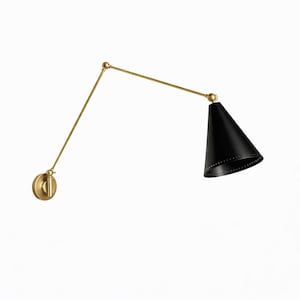 May include: A wall-mounted, adjustable lamp with a black conical shade and a brass-colored arm and base. The shade has a series of small holes around the bottom edge. The lamp is designed to be mounted on a wall.