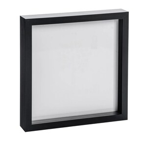 May include: A black square picture frame with a white mat. The frame is made of wood and has a simple design.