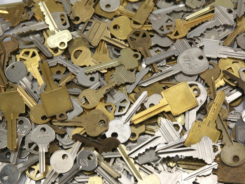 A mix of silver and yellow brass keys. They are in used condition and consist of cut and uncut keys. Types of keys can include, house, file cabinet, padlock, door, car, equipment, and more.  They are great for crafting, and mixed media art projects.