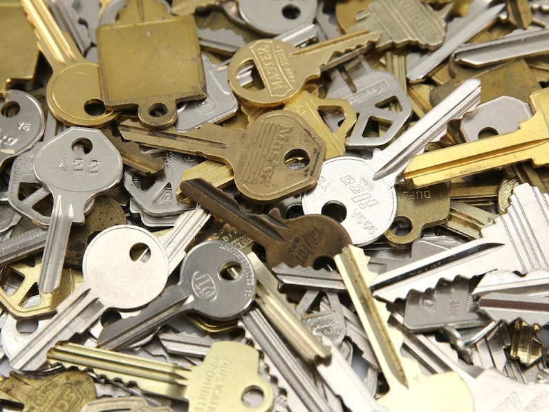 A mix of silver and yellow brass keys. They are in used condition and consist of cut and uncut keys. Types of keys can include, house, file cabinet, padlock, door, car, equipment, and more.  They are great for crafting, and mixed media art projects.